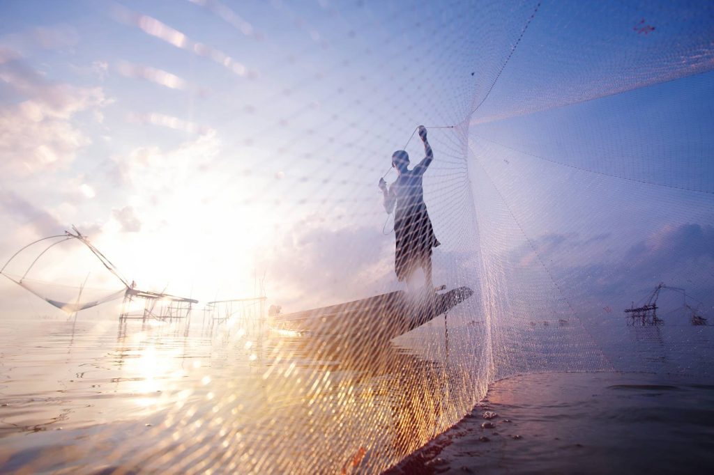 fishermen boat fishing with large fishnet silhouette scene morning 1024x682 1